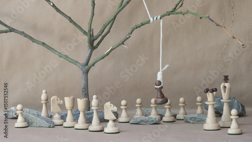 chess piece black pawn hanging on noose among white chess pieces