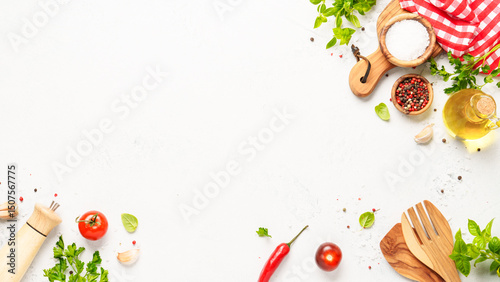 Spices, herbs and vegetables with olive oil on white kitchen table.