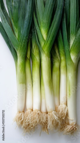 Fresh Leeks Arranged Neatly on a White Background Ready for Cooking in Variou...