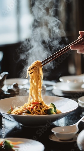 Steaming Noodles Lifted With Chopsticks in a Dining Setting During Dinner Time
