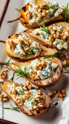 Grilled Pear Halves With Blue Cheese and Walnuts Served on a White Platter