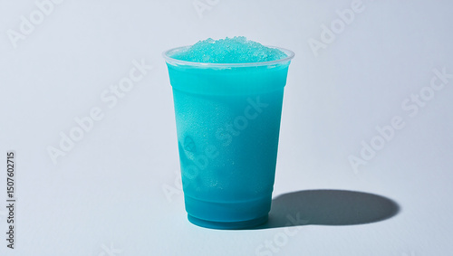 Refreshing blue raspberry slushie drink in plastic cup on white background shot