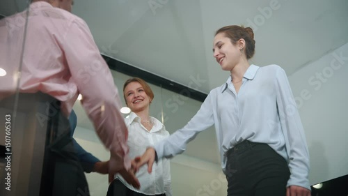 Business teams join hands to show unity of cooperation.