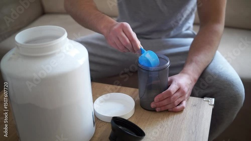 Scooping whey protein from a plastic jar