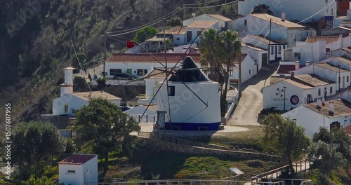 Aerial view of small village with windmill and picturesque rooftops, Odeceixe, Portugal