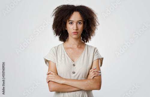 Resentment and upset, emotions and facial expressions. Strict offended millennial african american curly female student in casual, crossed arms and sadly looks at camera, isolated on gray background photo