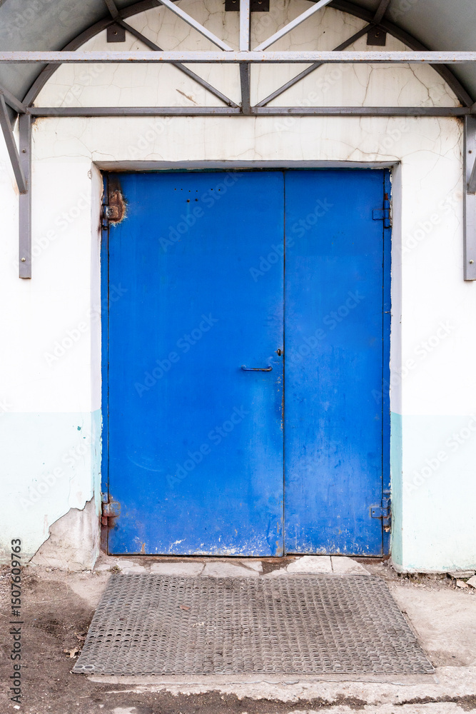 Fototapeta premium closed blue painted steel double door in building