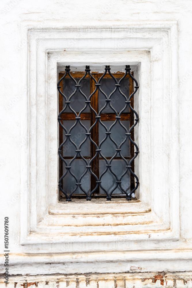 Fototapeta premium window with openwork lattice in old monastery wall