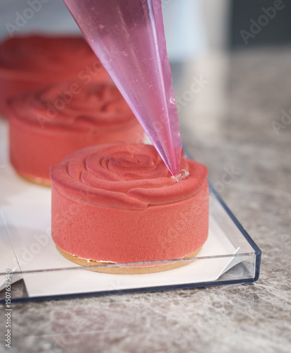 Pastry Chef Finishing a Rose-Shaped Mousse Petit Gâteau with Elegant Decoration