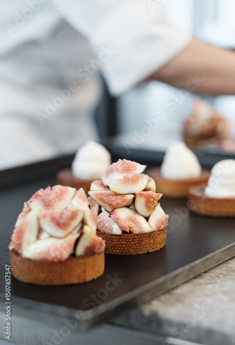 Fresh Fig Tarts Being Assembled by a Pastry Chef in a Gourmet Cafe