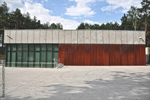 Wallpaper Mural  Modern single-story low building with a flat roof made of corten, concrete, and glass, large glass windows in the forest Torontodigital.ca