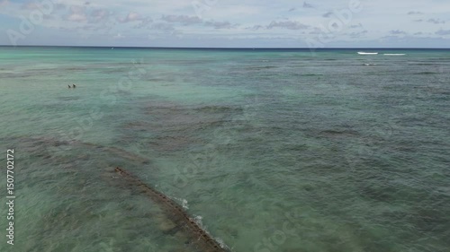Pull back drone shot of turquoise ocean