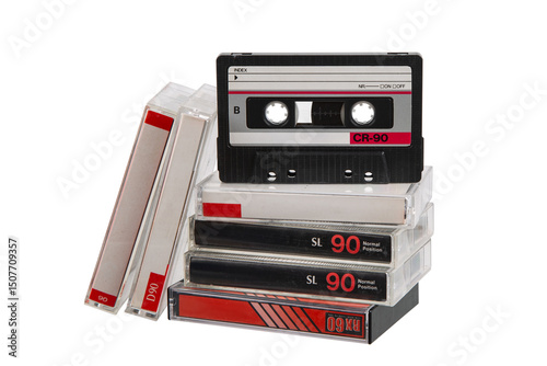 Stack of retro audio cassette tapes with one positioned upright, isolated on white back photo