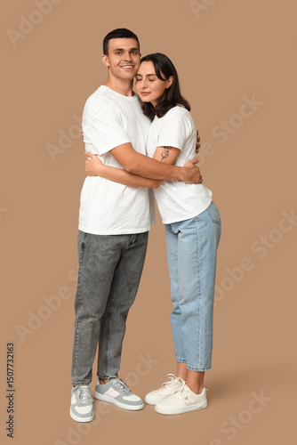 Cheerful young couple huggi...