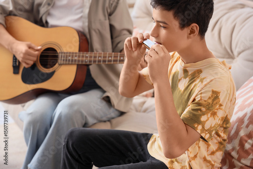 Teenage boy playing harmoni...