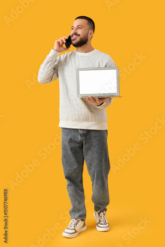 Young man with laptop talki...