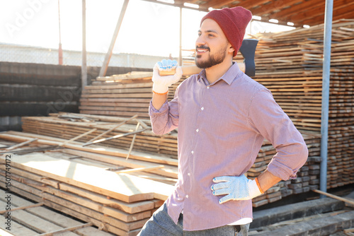 Male carpenter with axe at ...
