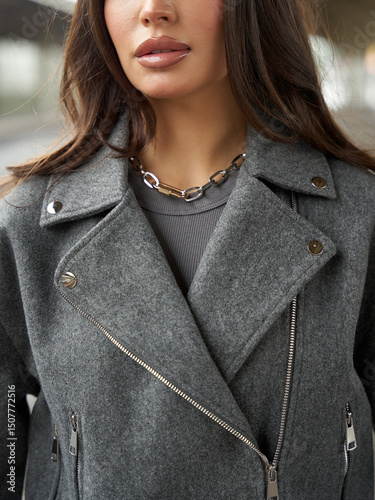 Stylish woman in casual street style outfit poses confidently in urban setting