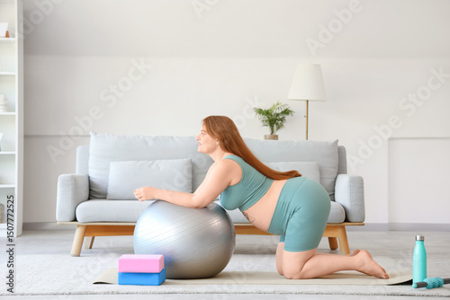 Pregnant woman exercising w...