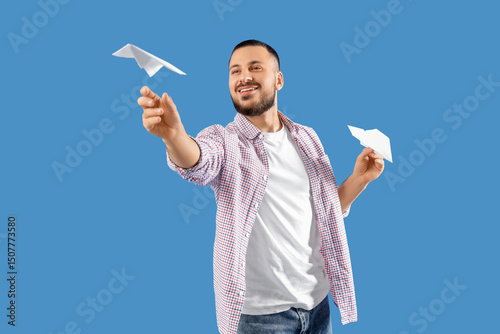 Young man with paper planes...