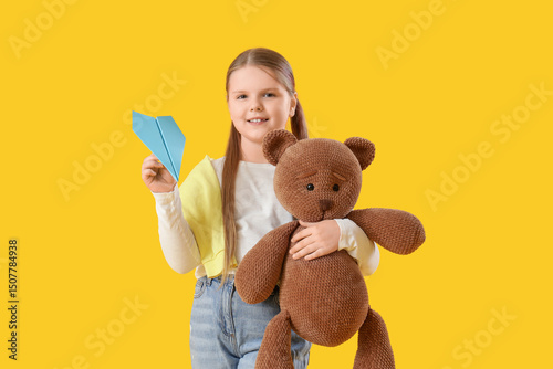 Cute girl with paper plane ...