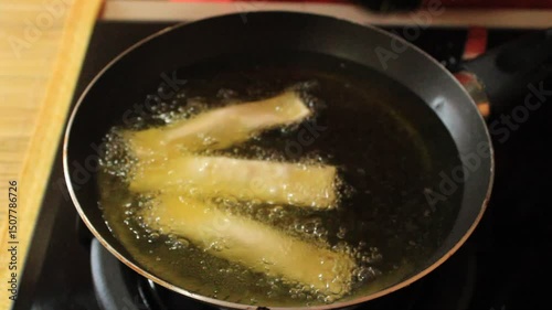 Wallpaper Mural Chef Frying Dumplings in Hot Oil with Tongs on Stove Torontodigital.ca