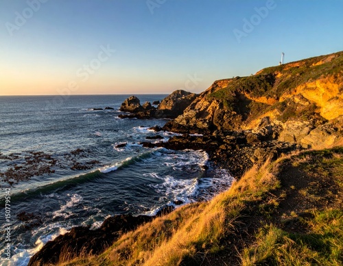 Serene Coastal Landscape at Sunset with Rocky Outcrops and Waves