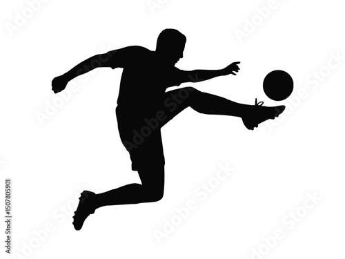 Silhouette of soccer player kicking ball