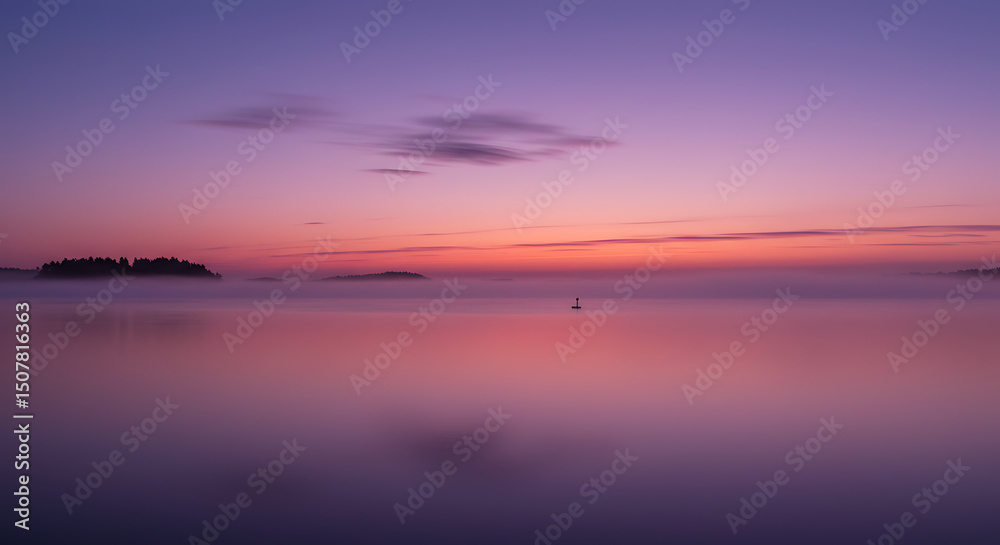 Naklejka premium Serene Sunset over Misty Lake Island Silhouette and Calm Waters
