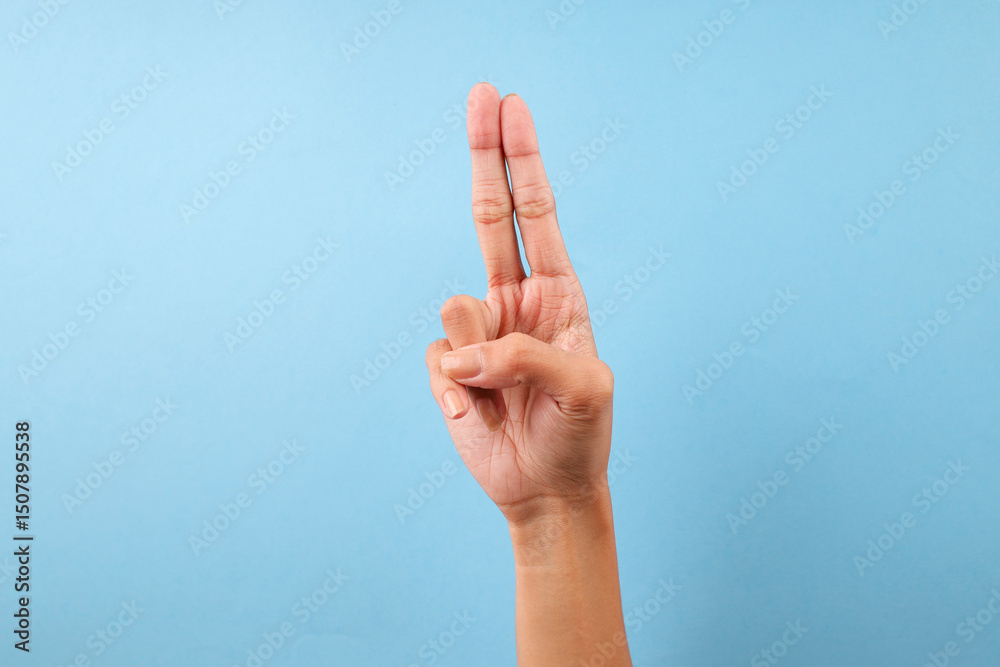 Finger Spelling Letter U In American Sign Language Isolated On Blue Background Finger Spelling Letter U In American Sign Language Isolated On Blue Background