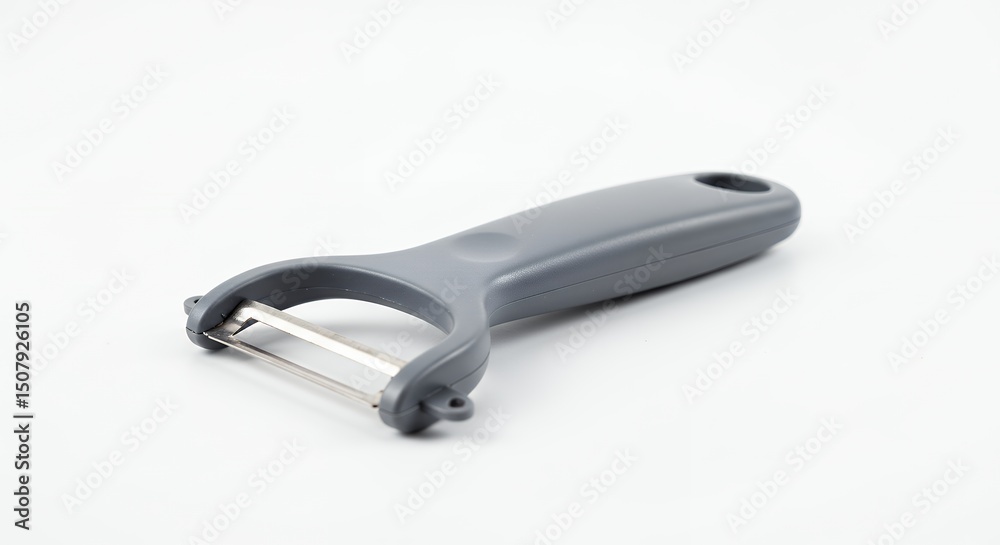 Obraz premium Gray vegetable peeler on white background