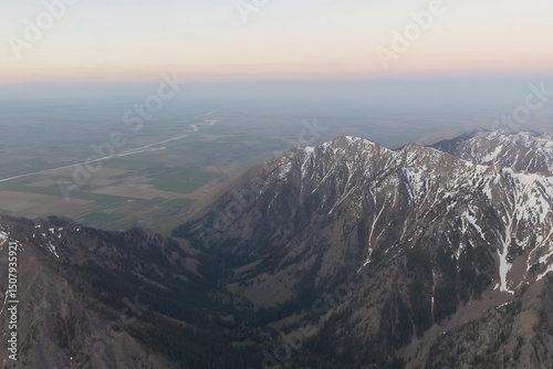 Mountain range against clear sky and plains