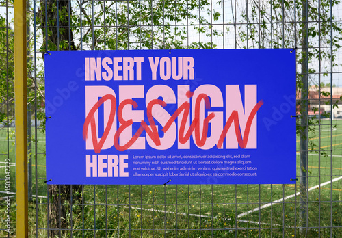 White mockup template info panel displayed on a fence near a sports field.