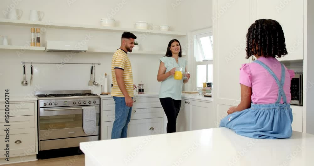 Family enjoying morning in kitchen, woman pouring orange juice, daughter smiling Family enjoying morning in kitchen, woman pouring orange juice, daughter smiling