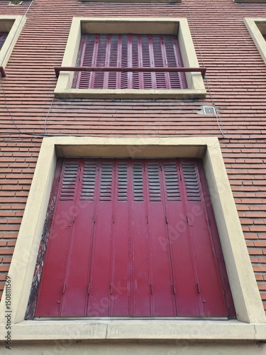 red window on a wooden house