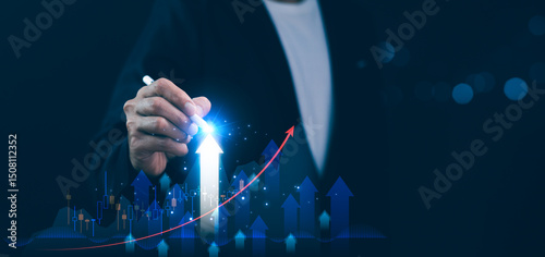 Obraz na płótnie Businessman using stylus pen pointing a glowing graph chart with upward arrow, business growth, financial success, market improvement. Concept strategic planning, investment analysis, goal economy. w salonie