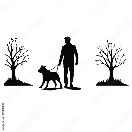 Man walking dog in park with bare trees