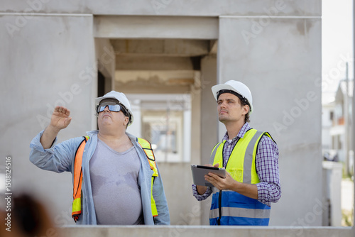 Wallpaper Mural In the Industrial Engineering Facility: Diverse Group of Engineers, Technicians, and Specialists on a Meeting, Have Discussion, Analyse Engine Design Technical Drafts that are Lying on the Table Torontodigital.ca