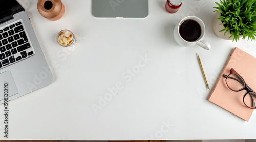 Cropped shot of modern workspace with blank screen laptop, frame, pencils, coffee cup and vase on white table with white wall background    