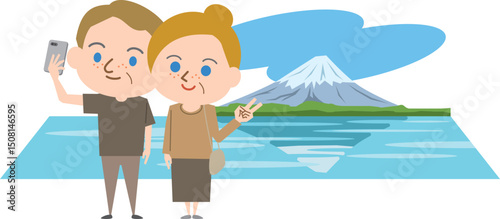 外国人のシニアカップルが富士山をバックに自撮りをしている