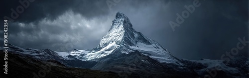 Dramatic Snowy Mountain Peak Under Stormy Sky