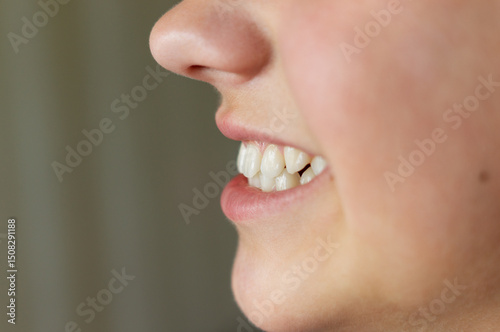 Even white healthy teeth of a child or person close-up side view. Correct bite of teeth