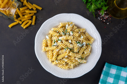 Cheese fusilli pasta in a plate. Turkish name; Peynirli makarna burgu photo