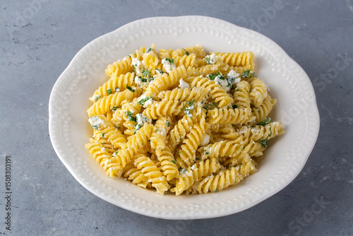 Cheese fusilli pasta in a plate. Turkish name; Peynirli makarna burgu photo