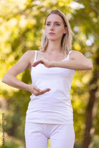 woman practicing tai chi quan in the park photo
