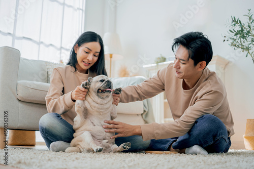Asian family stay at home together with dog on holiday. Love couple lifestyle.