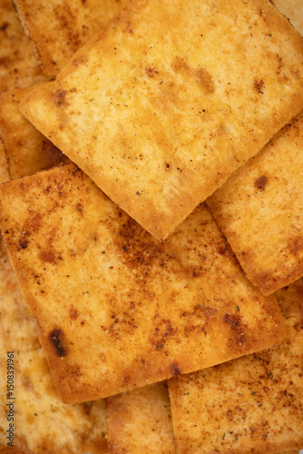 Nacho chips texture. Tortilla chips. Taco chips. Close-up. Food background. Tasty snack. Group of crispy corn chips isolated on white background.