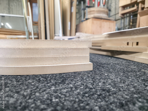 Stacked wood pieces ready for construction in a workshop during daylight hours