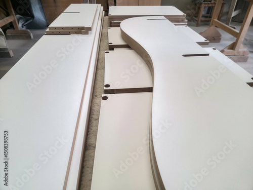 Crafting components for a musical instrument in a woodworking workshop during daylight hours