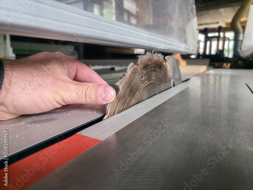 Woodworker operates table saw to cut lumber with precision in a workshop setting filled with tools and materials